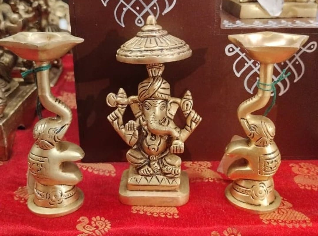 Ganesha with two elephants holding oil lamps