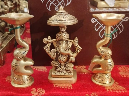 Ganesha with two elephants holding oil lamps